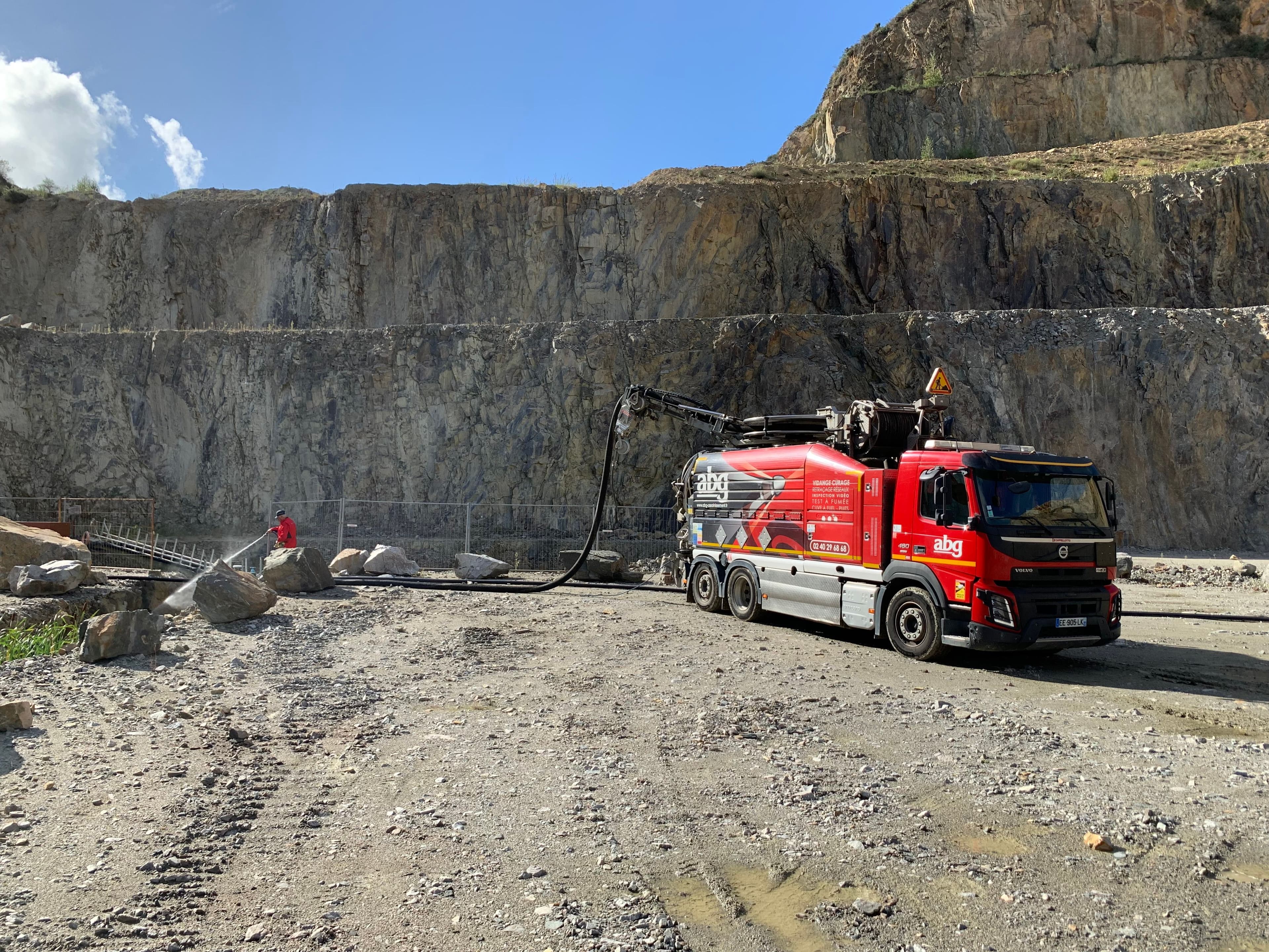 Camion ABG Assainissement en intervention de pompage de puits perdu dans une carriere en Loire Atlantique avec technicien et jet haute pression.